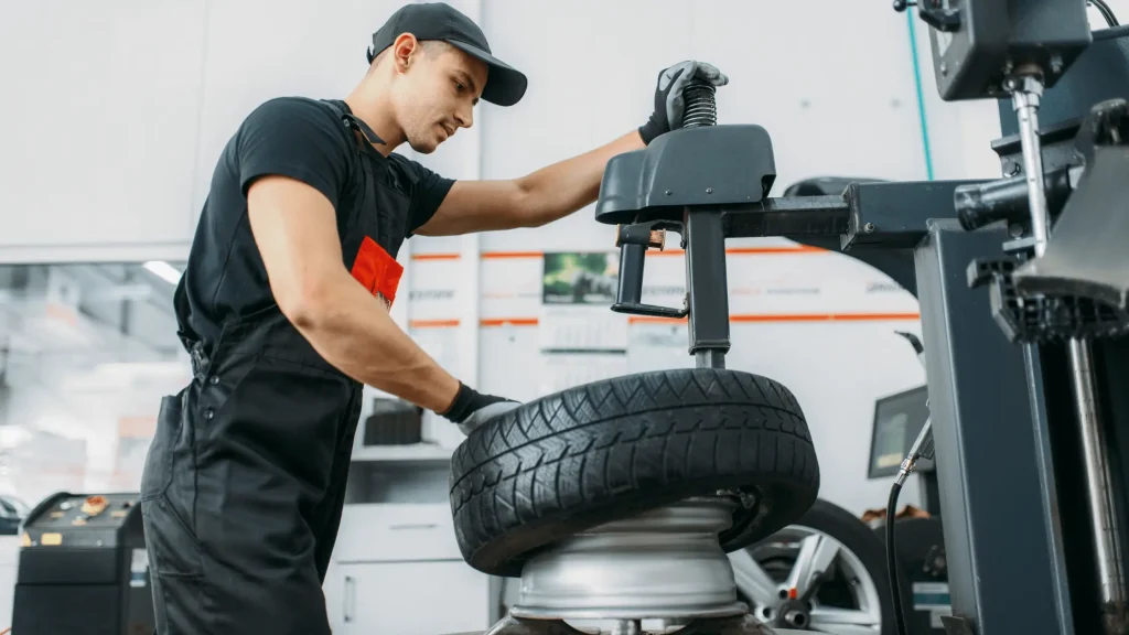 Mobile mechanic working on tire